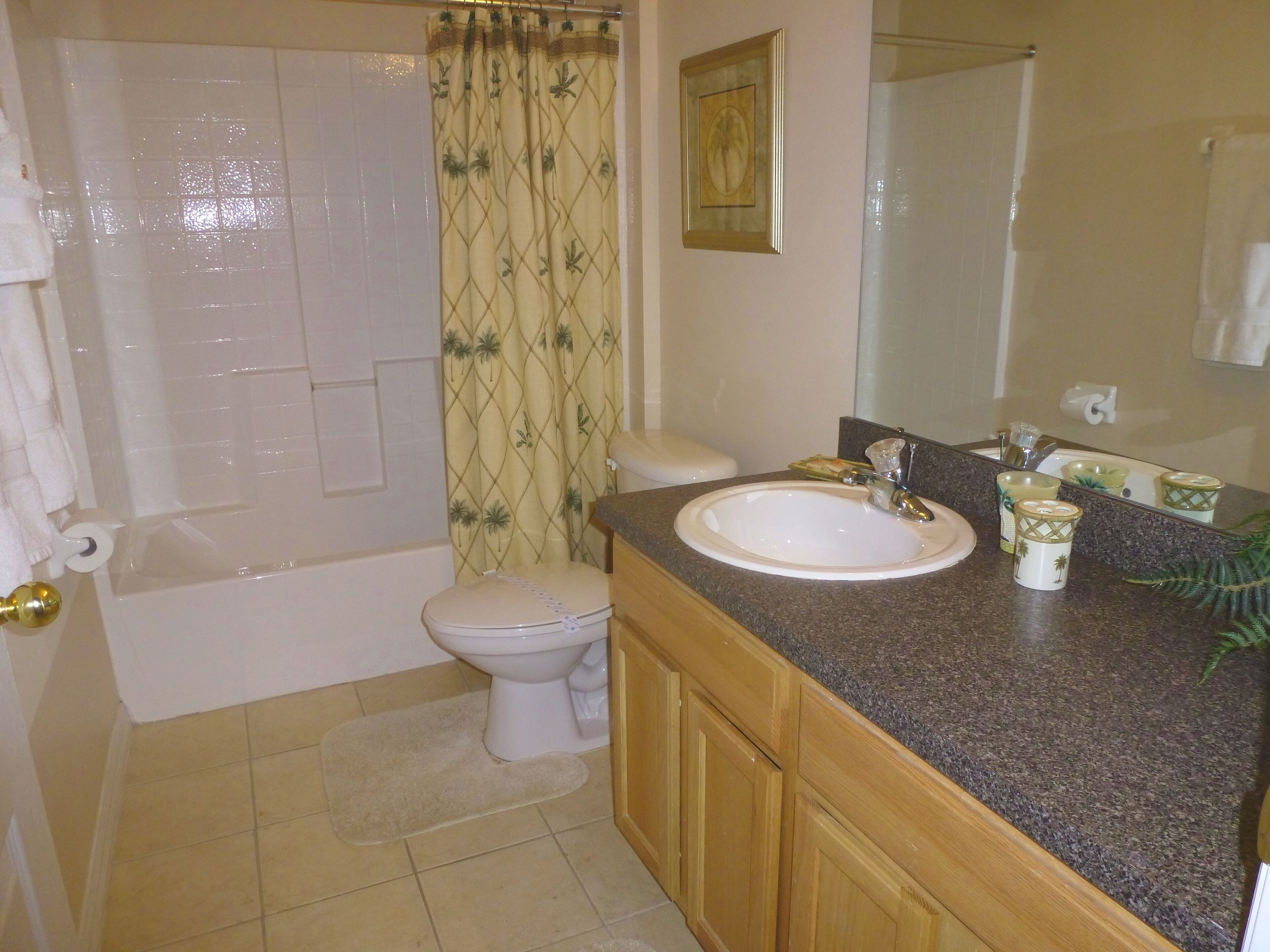 A bathroom with a bathtub, toilet, and sink.