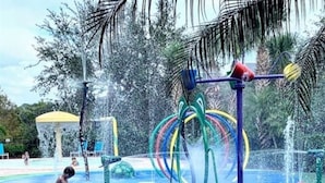 A water park with a water play area, including a water fountain and a water slide.