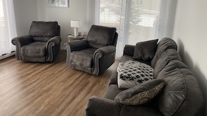 A living room with two armchairs, a sofa, a small table with a lamp, and sheer curtains. - Relax & Enjoy the Beautiful Sunsets on Lake Minnewaska.  (Starbuck)