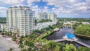 A high-rise hotel with multiple balconies, a river, and a bridge. - Serenity Ocean Luxury Condo (Boynton Beach)