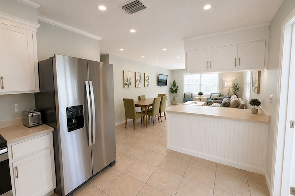 The kitchen overlooks the pool as well as teh living/dining area.