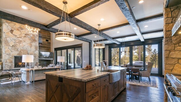 A spacious kitchen with a large island, stone walls, and a rustic ceiling. - Bound to Impress. Private Hot Tub, Golf Access & Exclusive Club Amenities! (Truckee)