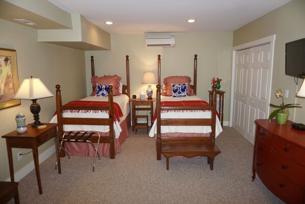 A bedroom with two wooden beds, a desk, a chair, a dresser, and a TV. - Relax in downtown Brevard. (Brevard)