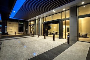 Welcome to our hotel, featuring a sleek glass facade and clean lines.