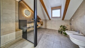 A modern bathroom with a skylight, a glass shower enclosure, and a wooden vanity. - Luxury Apartment "Weißhorn" with Mountain View and private Steam Sauna (Deutschnofen)