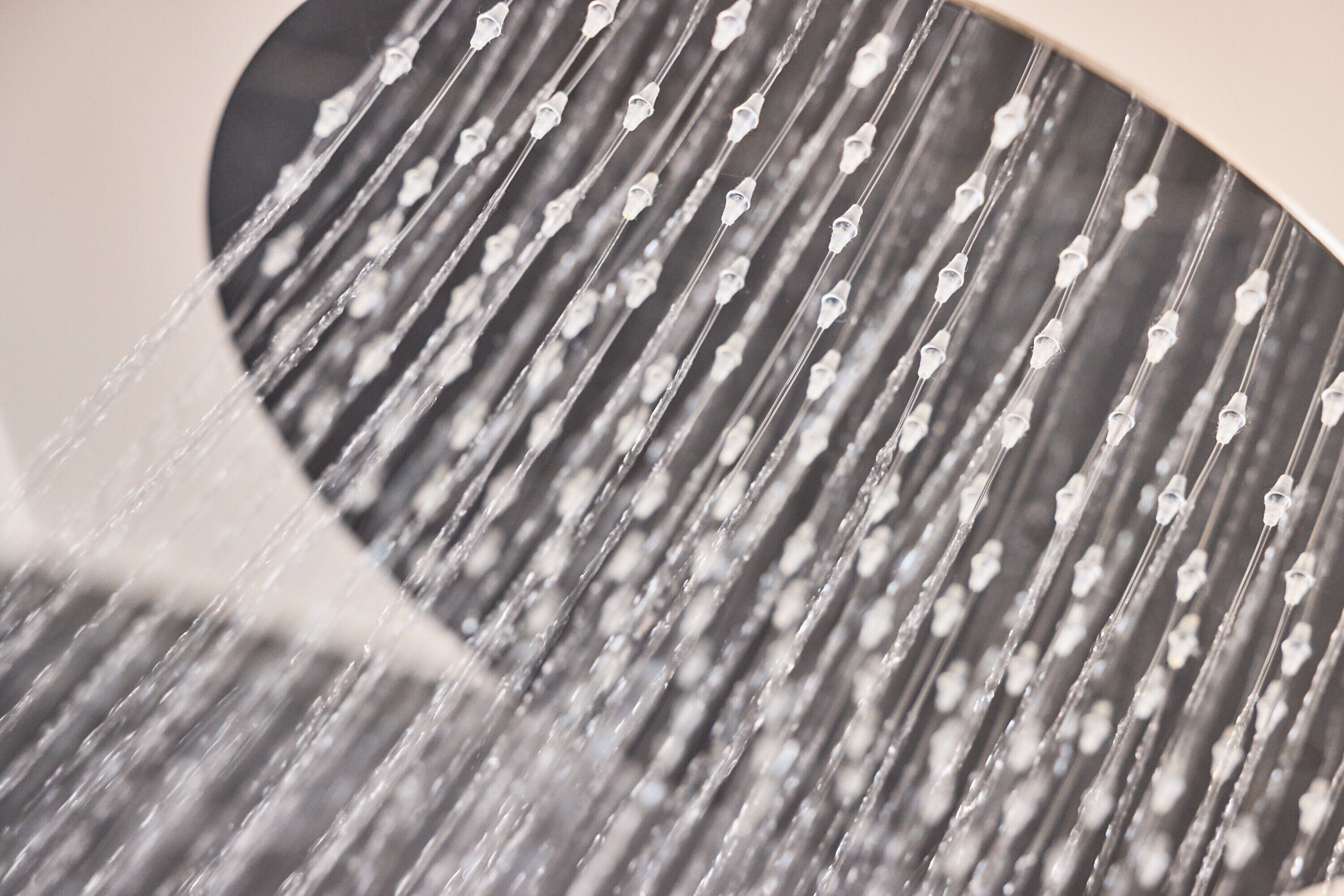 A close-up of a metallic surface with parallel lines and a curved edge.