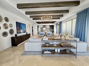 Relax in a stylish living space with a comfortable sofa set and a mounted television.