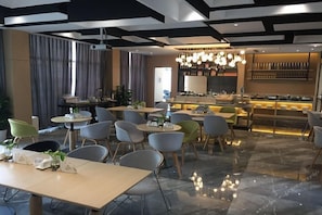 A modern restaurant with a bar area, multiple seating arrangements, and a polished marble floor. - Atour Hotel (Hangzhou)