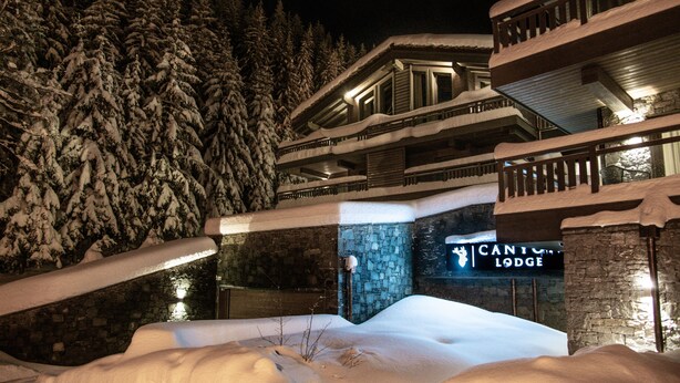 A snow-covered building with a sign reading "Cantina Lodge."