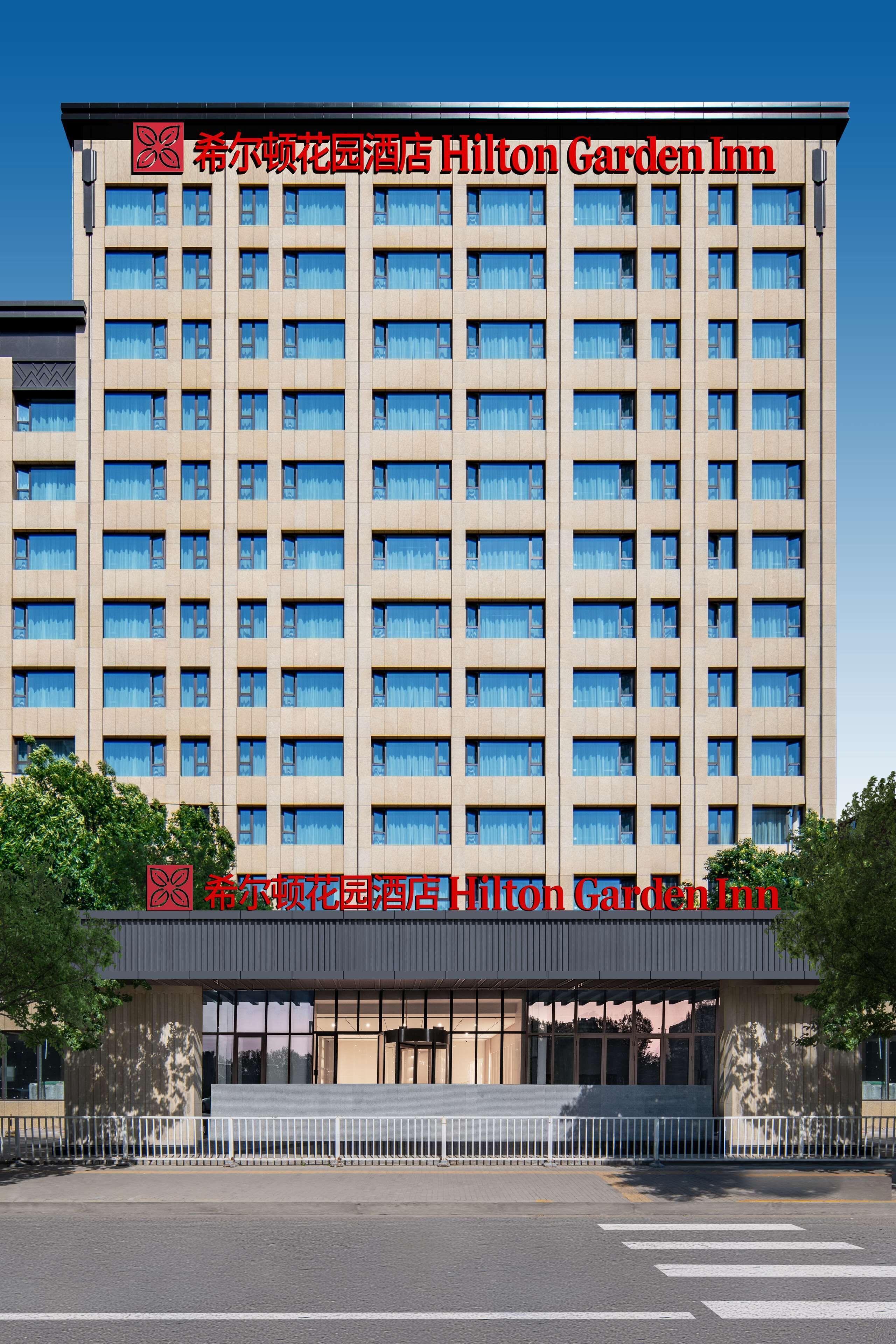 A multi-story hotel with a uniform facade, large windows, and a prominent entrance.