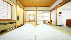 Una habitació japonesa tradicional amb fons de tatami, panells shoji i un sostre de fusta baix.