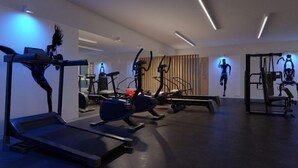 A modern gym with various exercise equipment, including treadmills and stationary bikes.