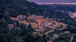 A resort with multiple buildings, a swimming pool, and a mountainous backdrop. - Angsana Corfu Resort & Spa (Corfu)