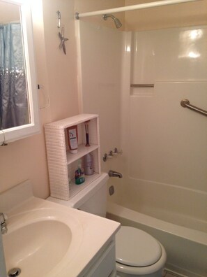 Combined shower/bathtub, towels, soap, toilet paper