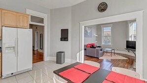 A modern apartment with a kitchen, dining area, and living room.