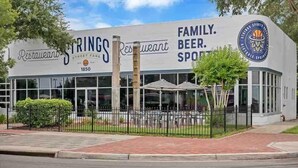 A restaurant named Springs Restaurant with a sign indicating it is family-friendly and offers beer and sports. - Stylish 2 BR apartment - perfect for relaxing! (Jacksonville)