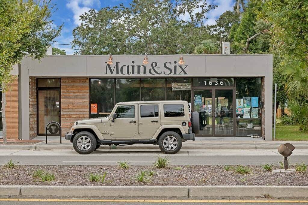 A building with a sign reading "Main & Six" and the number "1636" on the door.
