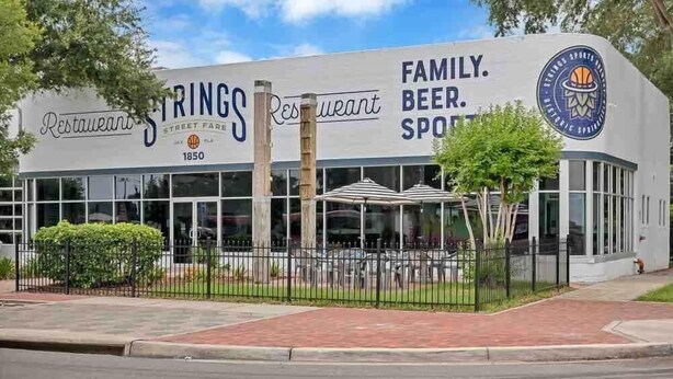 A restaurant named Springs Restaurant with a sign indicating it is family-friendly and offers beer and sports.
