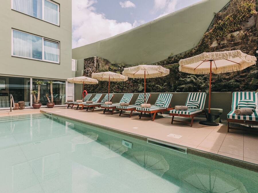 Indoor pool, outdoor pool, open 10:00 AM to 8:00 PM, pool umbrellas