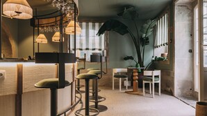 A bar area with stools, a counter, and hanging lamps. - Torel Terra Brava (Angra do Heroismo)