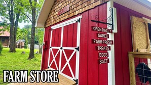 A red barn with a sign listing farm store offerings like eggs and bait. - Lakefront Airstream - Farm Animals - Fish, Swim, Boat, Hike/Bike 5+Miles Trails (Louisa)