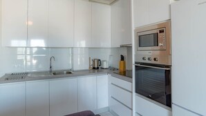 A modern kitchen with white cabinets, stainless steel appliances, and a built-in oven. - Beautiful sunny top floor apartment in Ciudad Quesada, Rojales (Ciudad Quesada)