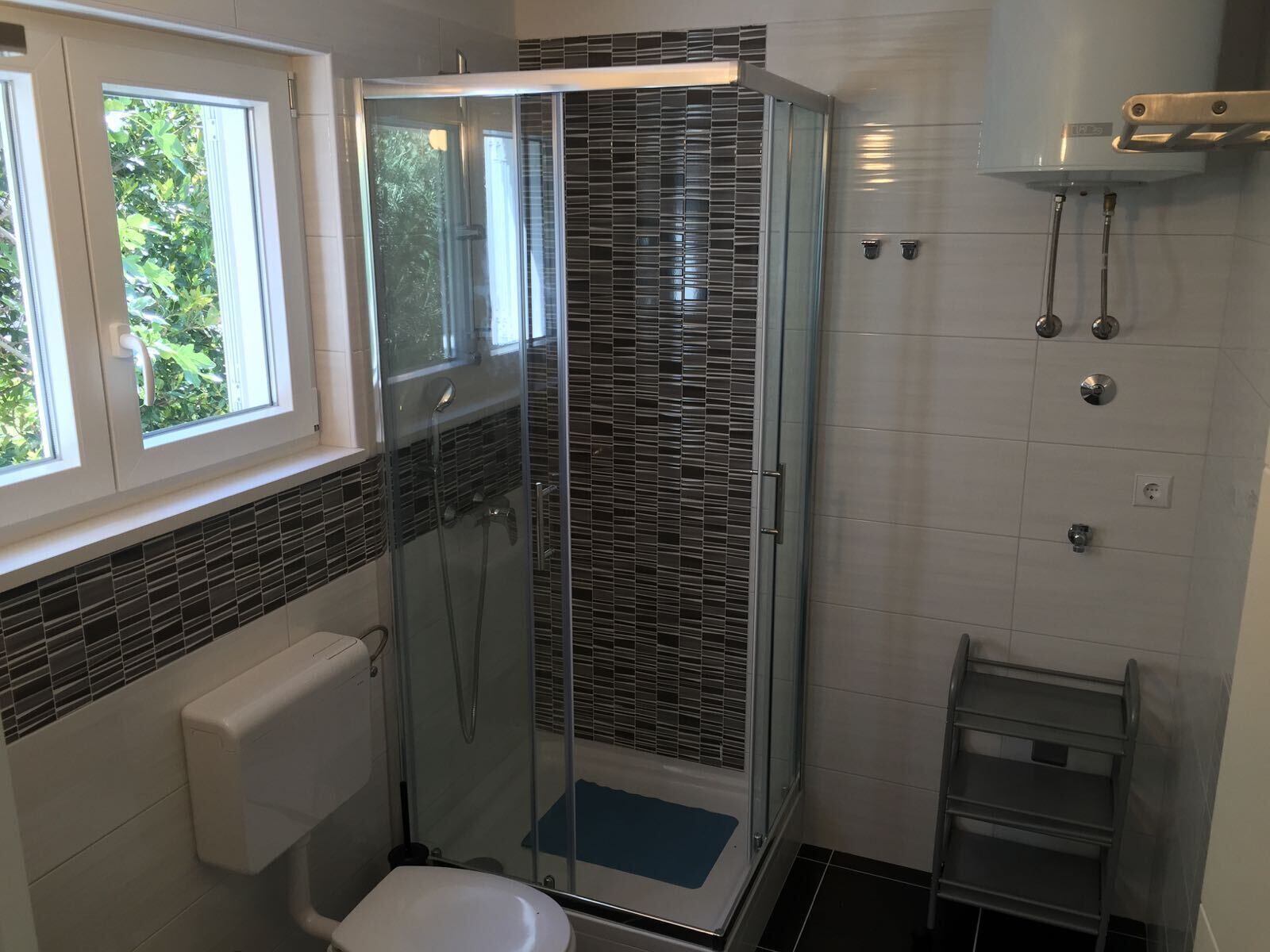 Shower, hair dryer, towels, toilet paper