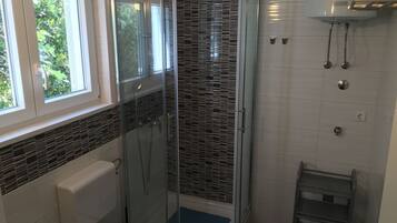 Shower, hair dryer, towels, toilet paper
