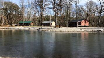 A tranquil lakeside setting with cabins and a dock.