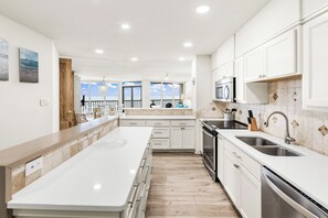 Enjoy cooking in this well-equipped kitchen with a central island, ample counter space, and integrated appliances.