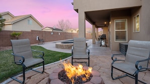 A patio area with two chairs and a fire pit. - Escondido by RedAwning (Hurricane)