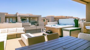 A rooftop terrace with outdoor seating, a hot tub, and a view of neighboring buildings. - Fun Times & Tan Lines by RedAwning (Washington)