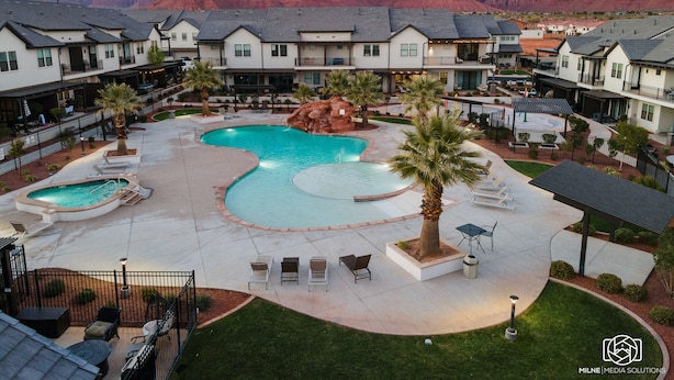 A resort with a large pool, multiple buildings, and a mountainous backdrop. - Ocotillo Springs #20 by RedAwning (Santa Clara)
