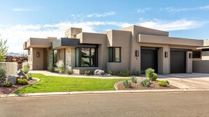 A modern two-story house with a stone facade, large windows, and a well-maintained lawn. - Enchanting Encanto #1 by RedAwning (Ivins)