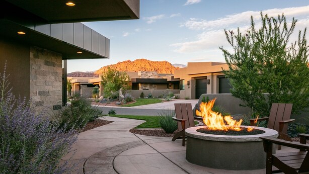 An outdoor patio with a fire pit, seating, and a view of a mountain. - Enchanting Encanto #1 by RedAwning (Ivins)