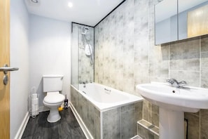 Combined shower/bathtub, hair dryer, towels, toilet paper