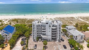 Un hôtel à plusieurs étages doté d’une cour intérieure, d’un parking et offrant une vue sur la plage et l’océan.
