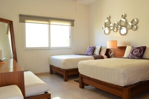 A hotel room with two beds, a desk, and a large window with blinds. - La Olas By Riviera Rentals (Playa del Carmen)