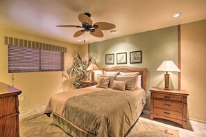 A bedroom with a bed, a ceiling fan, a nightstand, a lamp, and a dresser. - Indio Escape w/ Fire Pit & Resort Amenities! (Indio)