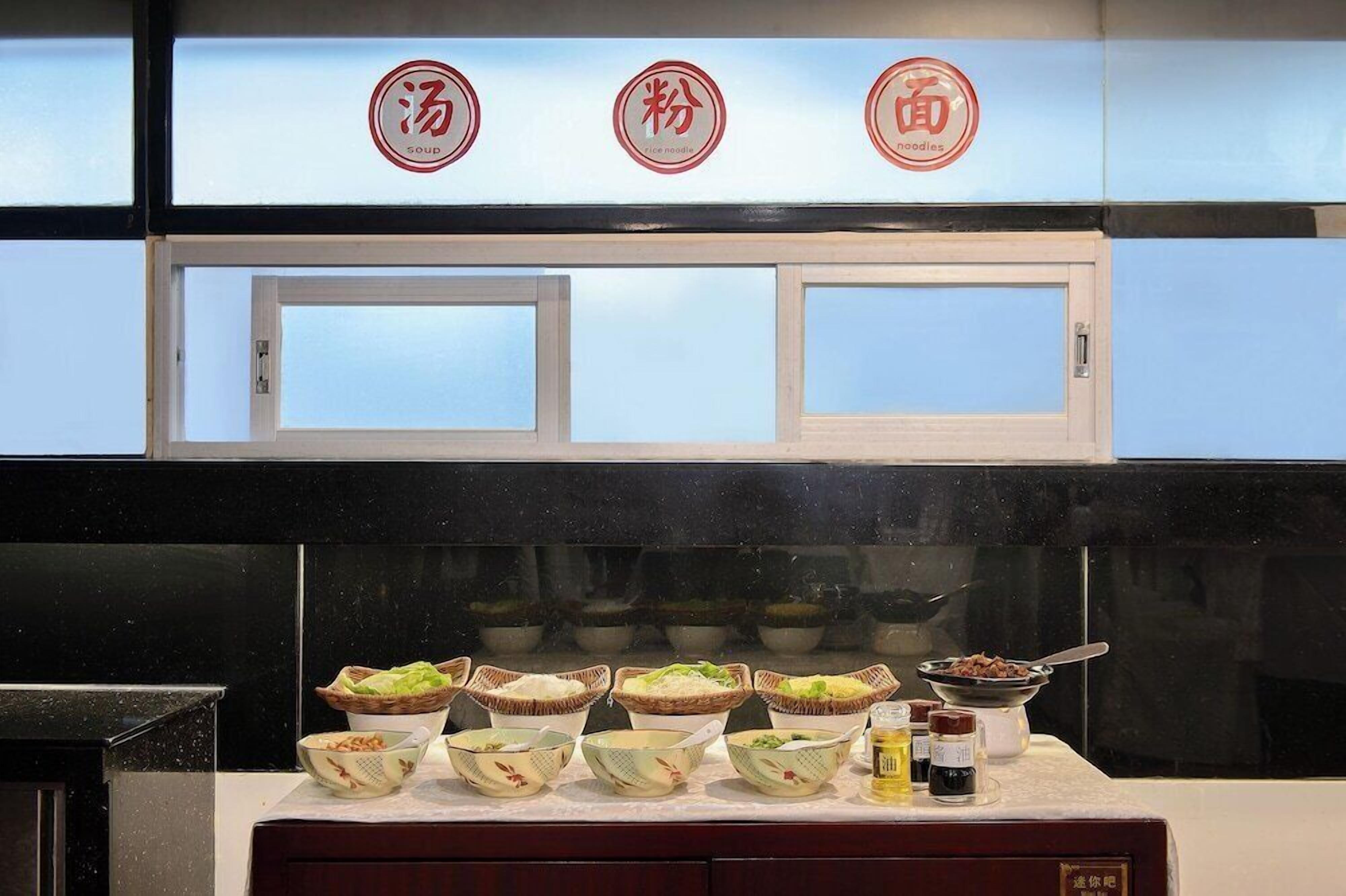A kitchen counter with various food items and condiments.