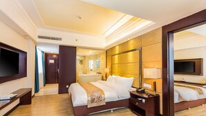 A modern hotel room with a large bed, a TV, a desk, and a bathroom visible through an open door. - Pasonda Hotel Foshan (Foshan)