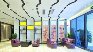 A modern lobby with a marble floor, seating area with sofas, and a large glass window. - Lavande Hotel Shenzhen Baoan Haiya Binfen City (Shenzhen)