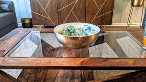 A modern dining table with a glass top and a brass bowl. - Zen Retreat w/ Hot Tub & Private Pool - Near Beach! (Panama City Beach)