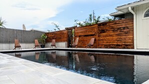 A swimming pool with a wooden deck and lounge chairs. - Zen Retreat w/ Hot Tub & Private Pool - Near Beach! (Panama City Beach)