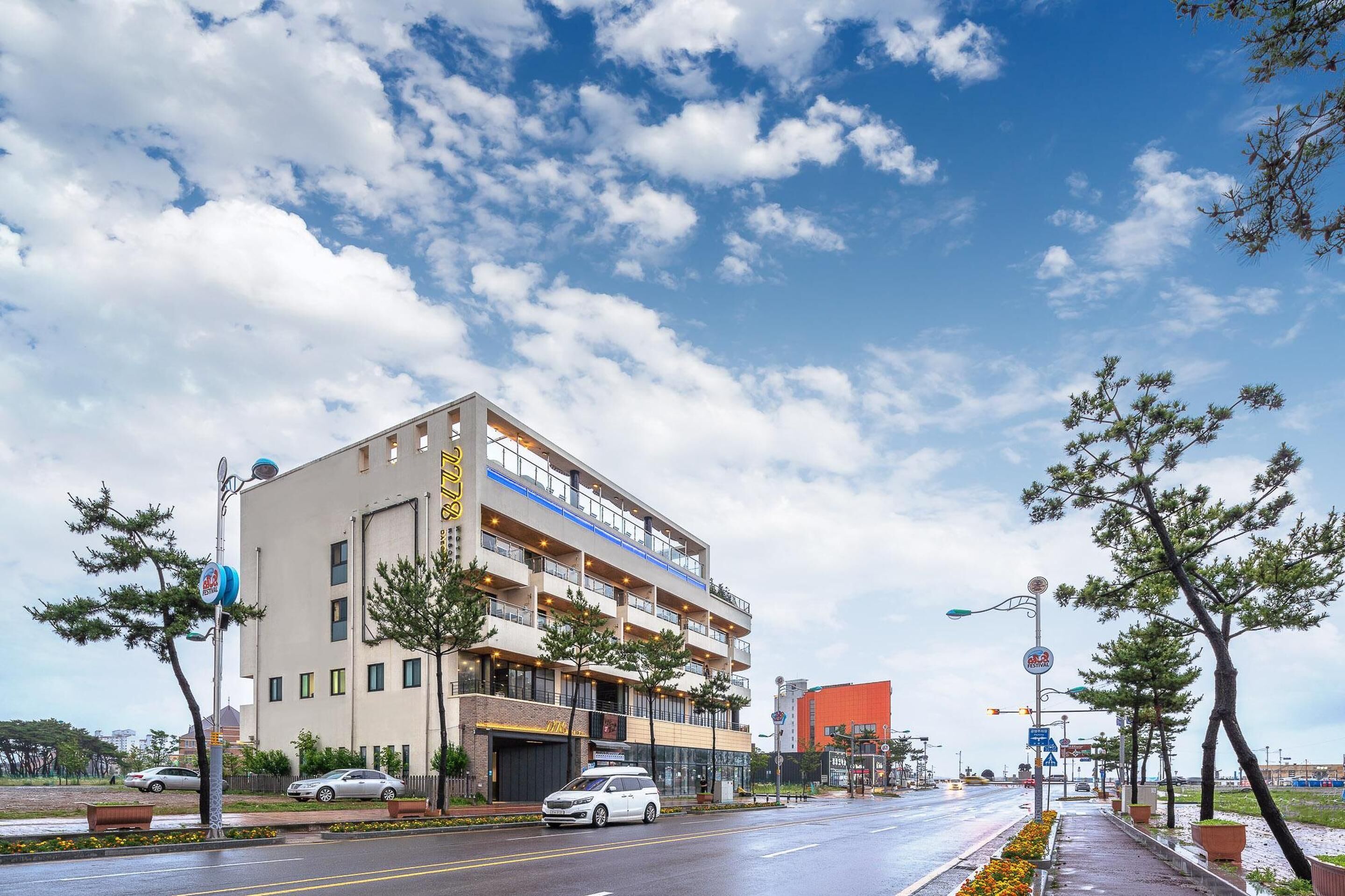 A multi-story building with a modern design, featuring balconies and large windows.