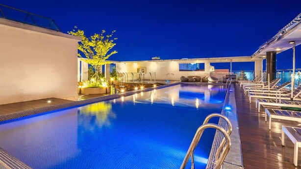 A rooftop pool with lounge chairs, a small garden area, and a clear night sky. - Daecheon 2278 Resort (Boryeong)