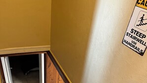 A staircase with a caution sign advising to use handrails.