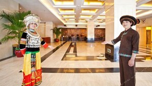 A lobby with a marble floor, a reception desk, and a large plant. - Guizhou Mansion (Beijing)