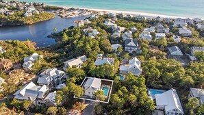 An aerial view of a coastal residential area with houses, a beach, and a body of water. - Endless Sunset - 30A, Heated Private Pool, Fire Pit, Steps to the Sand! (Santa Rosa Beach)