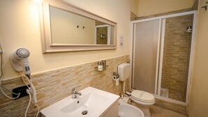 A bathroom with a sink, toilet, and a shower area. - SWEET EMOTIONS ROOM 81 (Bari)